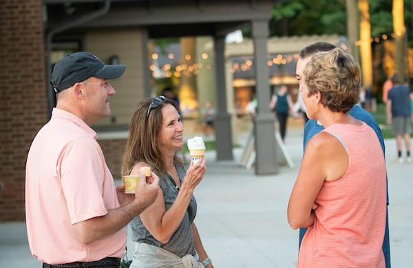 People smiling and eating ice cream